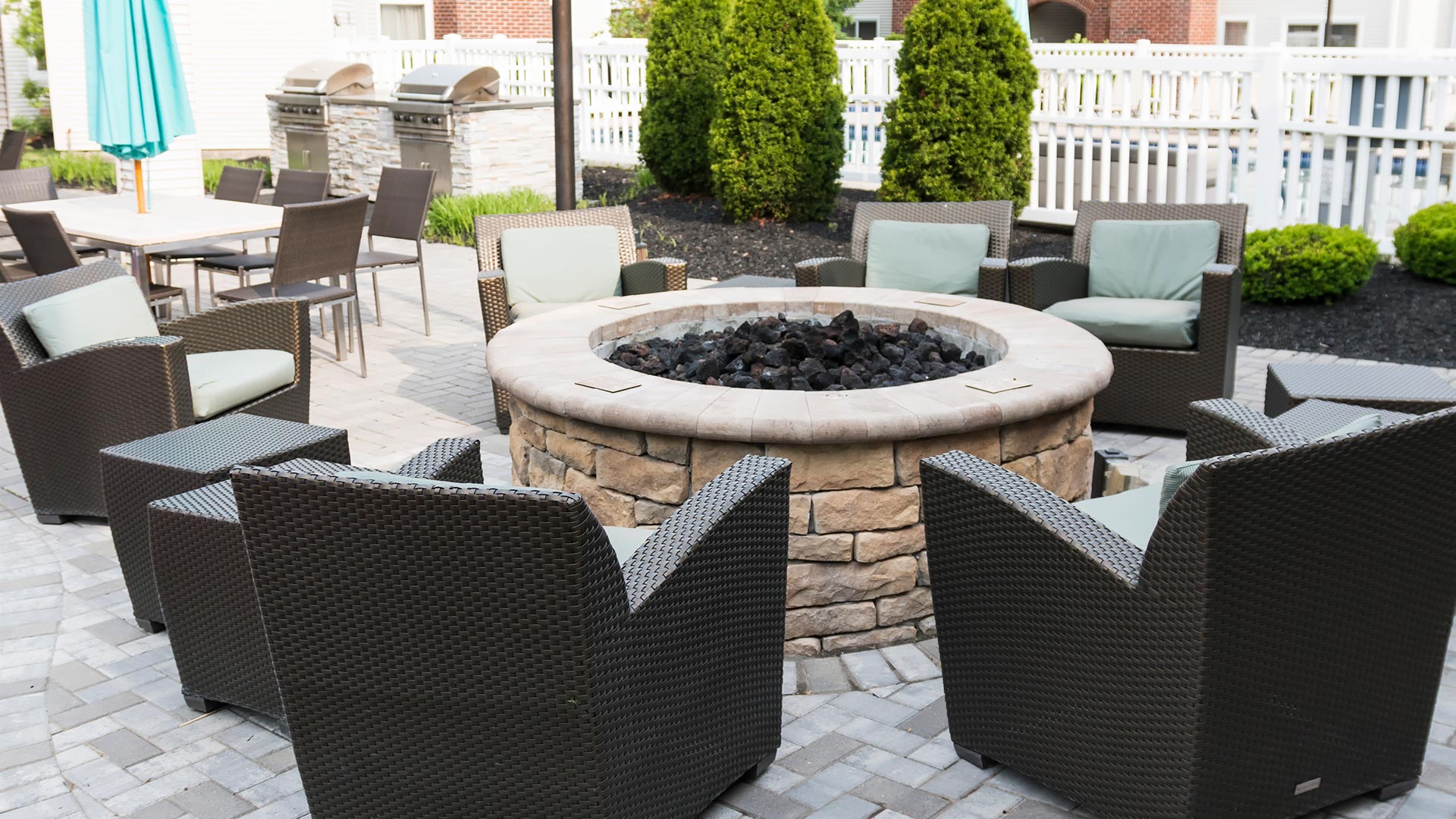 Custom fire pit and patio with chairs at a property in Ankeny, IA.