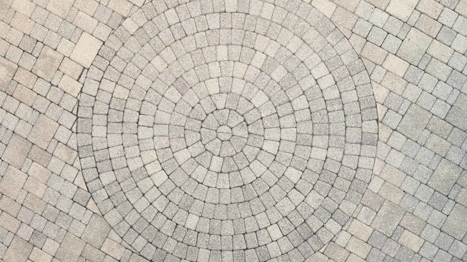 Custom paver patio with circular pattern in Bondurant, IA.