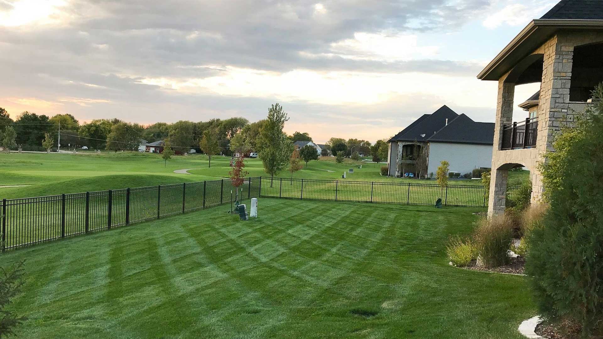 Lush, green lawn with mowing stripes in Ankeny, IA.