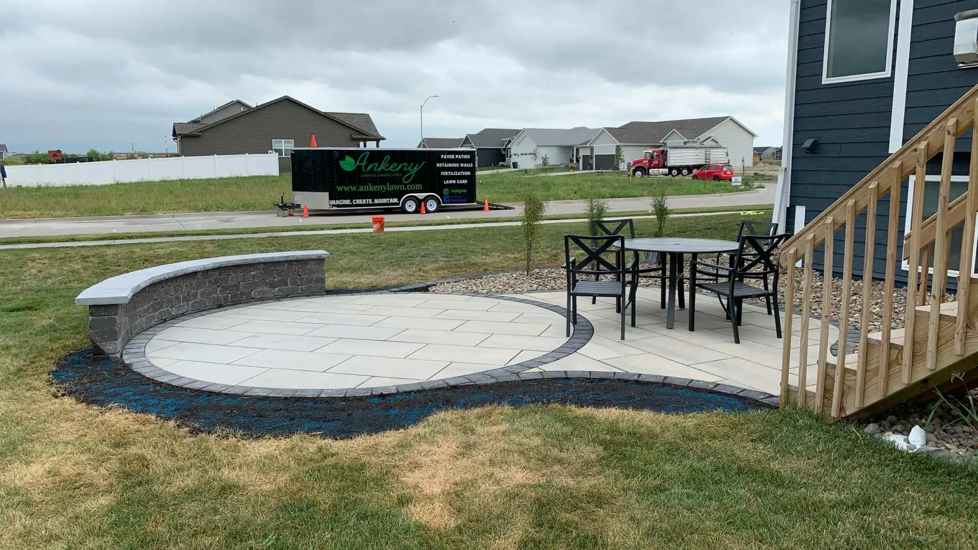 Patio with seating wall and landscape bed installed in Ankeny, IA.