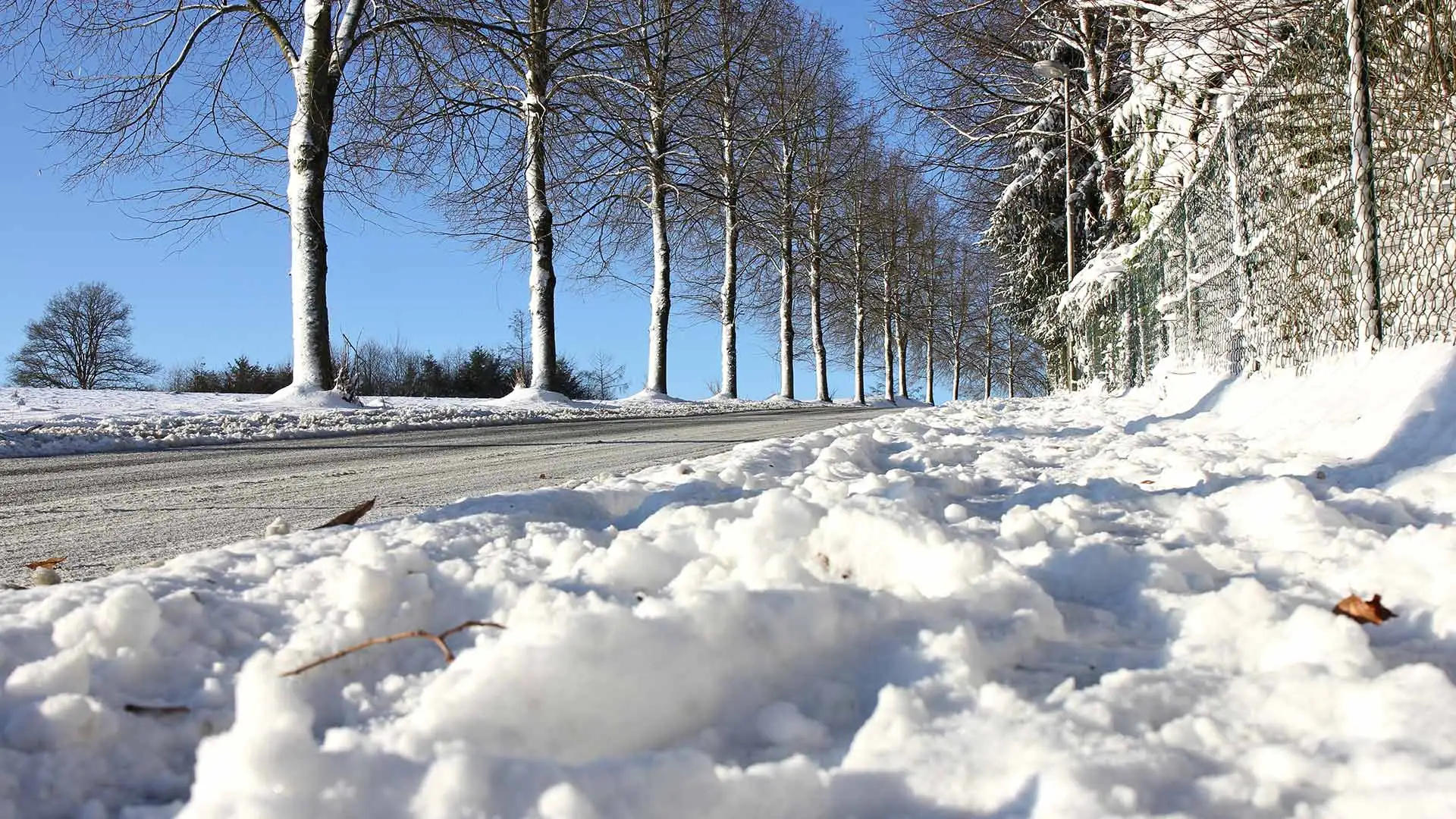 Street filled with snow left over after being plowed in Ankeny, IA.