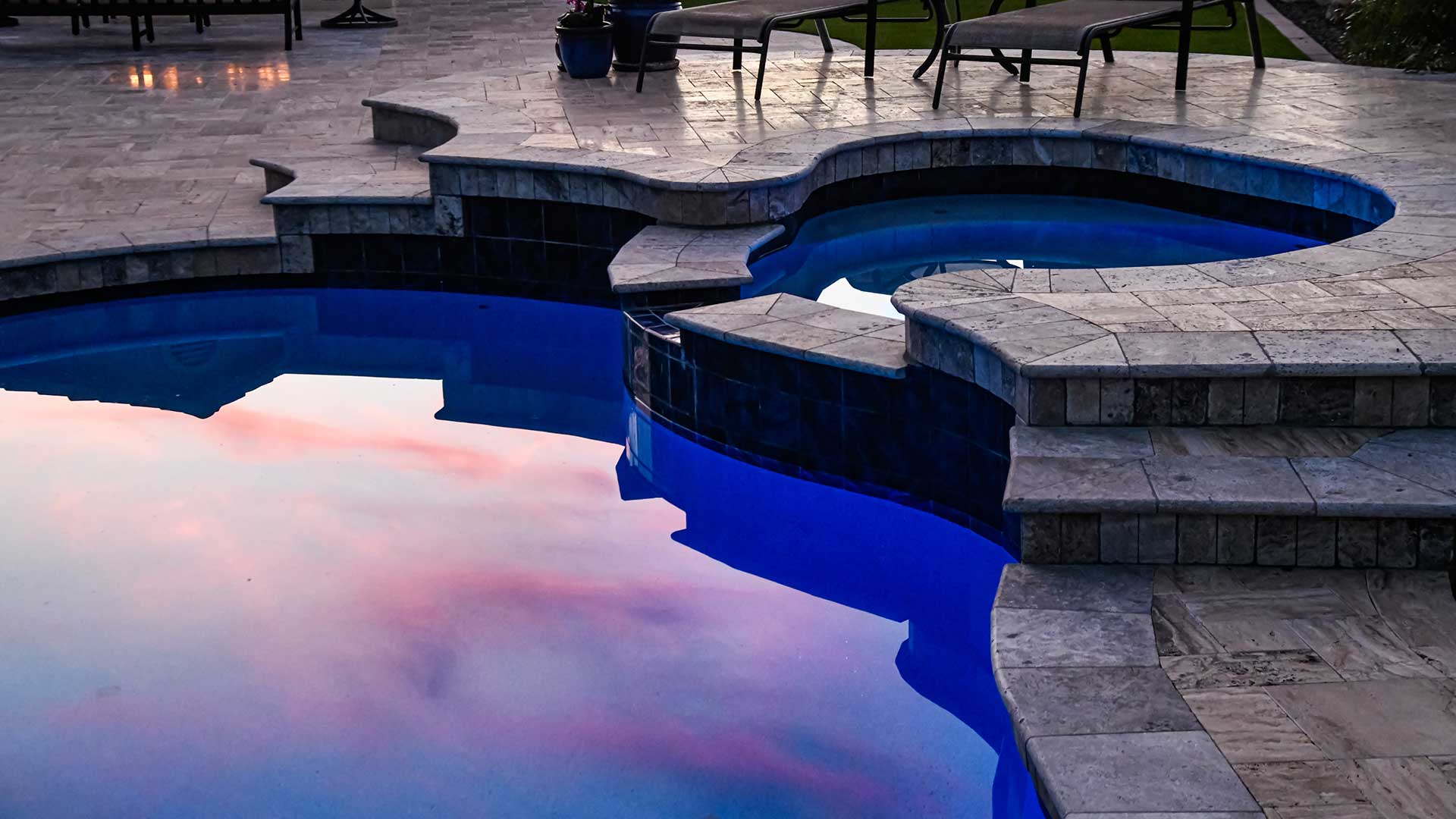 Swimming pool with custom patio installation in Ankeny, IA.