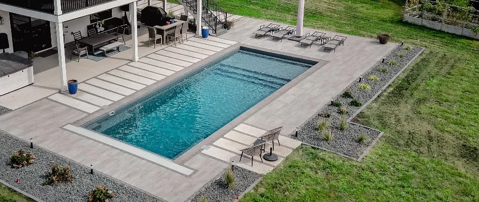 Lounge chairs and landscaping around a pool in Ankeny, IA.
