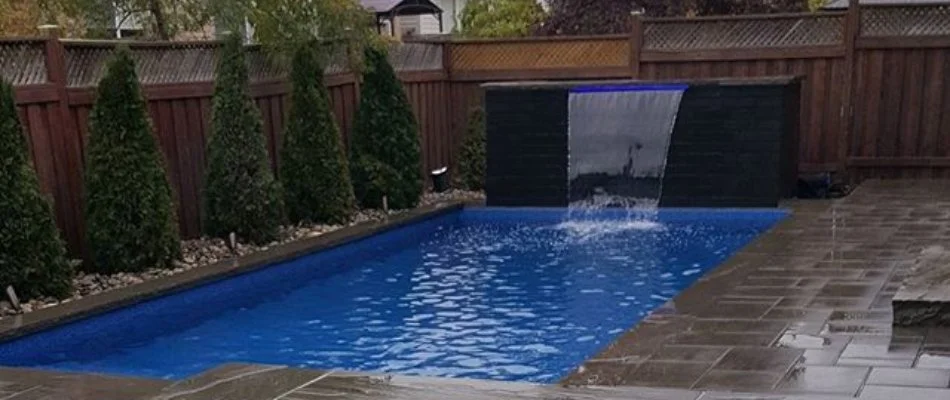 Pool in Ankeny, IA, with water feature.