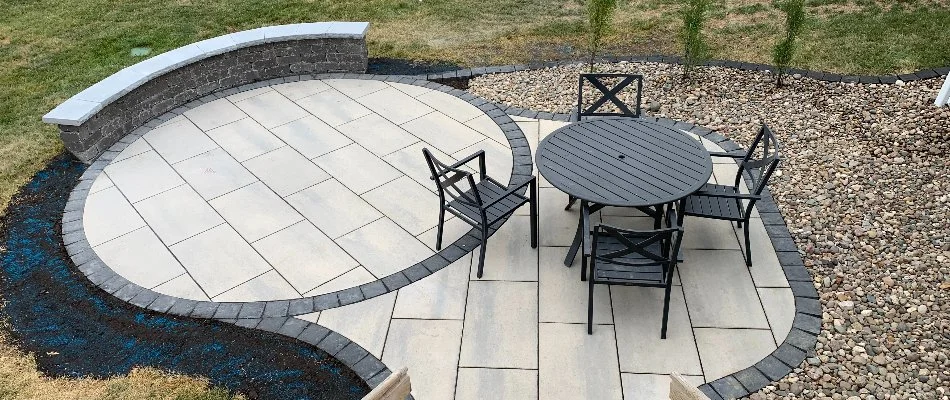 Round paver patio in Ankeny, IA, with table and chairs.