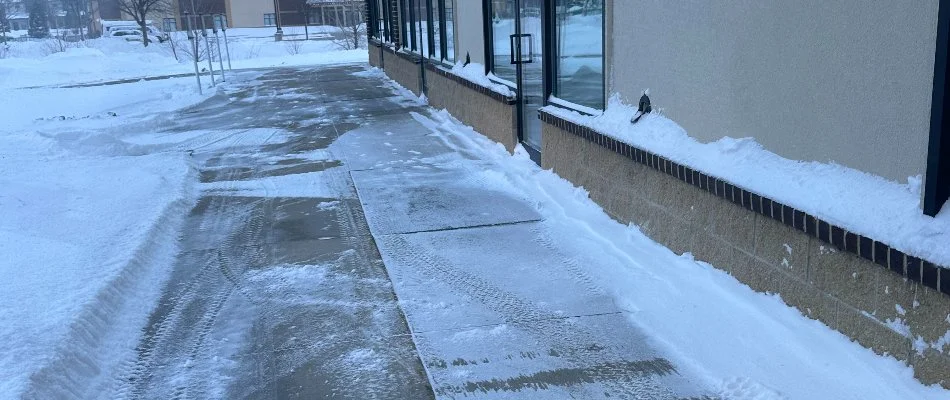 Snow cleared from a walkway in front of a building in Ankeny, IA.