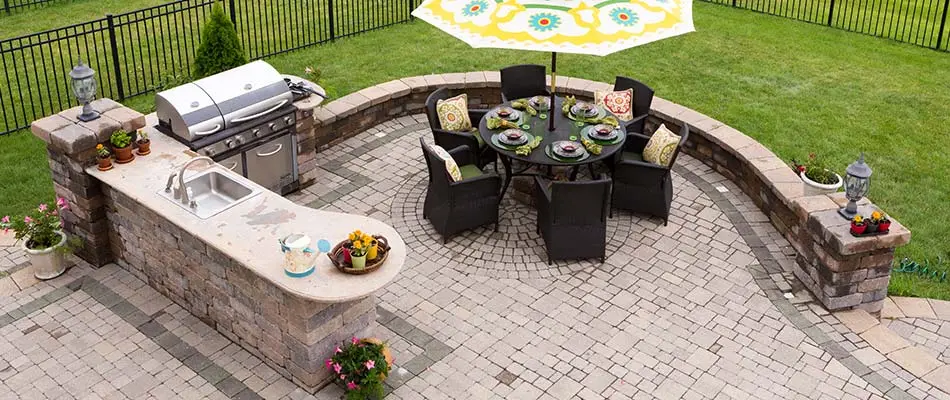 Custom outdoor kitchen with grill and sink near Ankeny, IA.