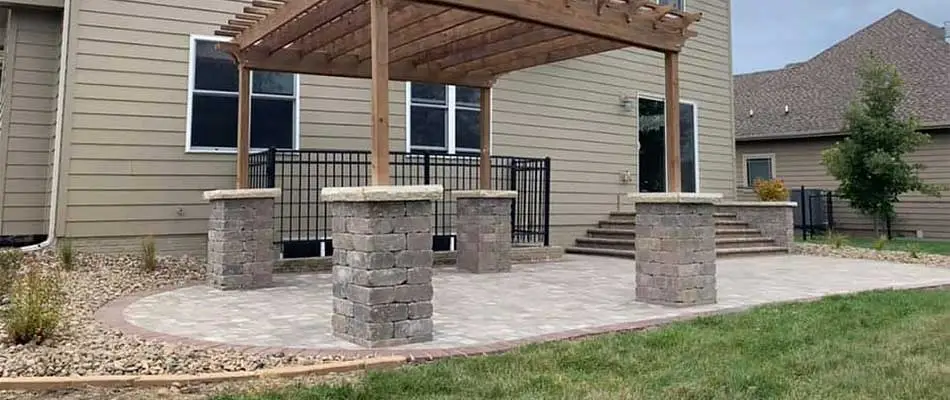 Custom patio with columned pergola near Bondurant, IA.