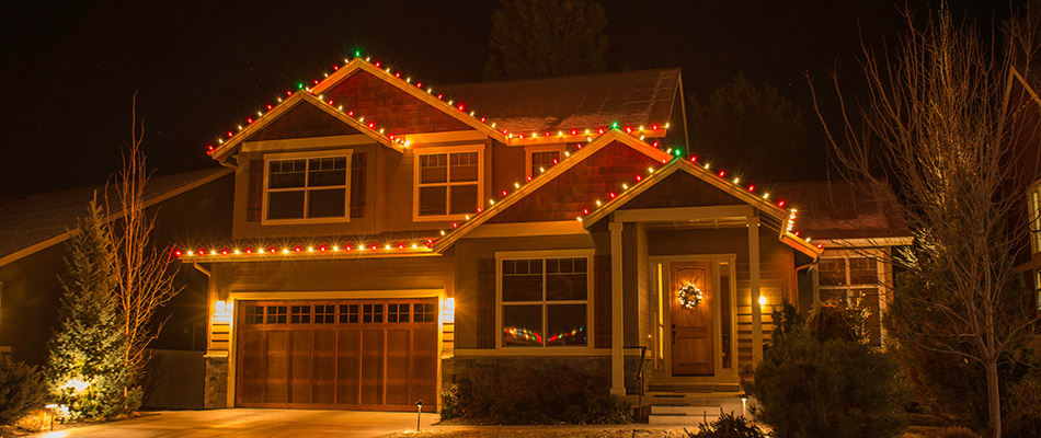 Holiday lights installed around perimeter of home's roof in Ankeny, IA.