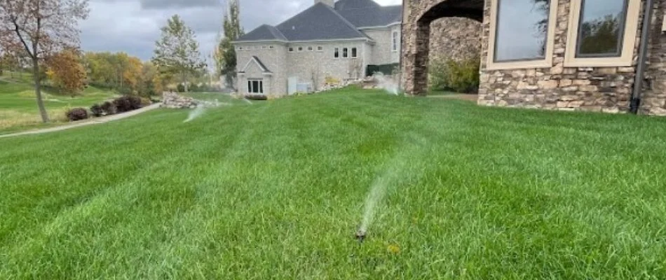 Irrigation system spraying water on a lawn in North Liberty, IA.
