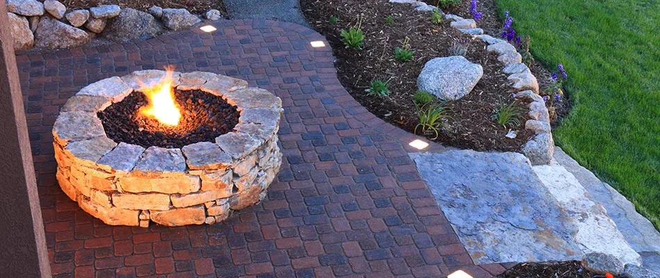 Natural stone fire pit and custom paver patio in Saylorville, IA.
