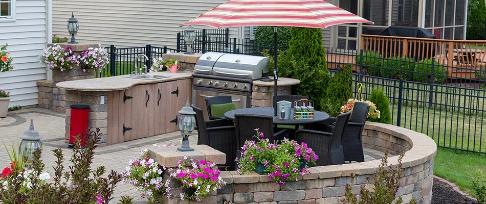 Custom outdoor kitchen area with grill and custom countertops in Bondurant, IA.