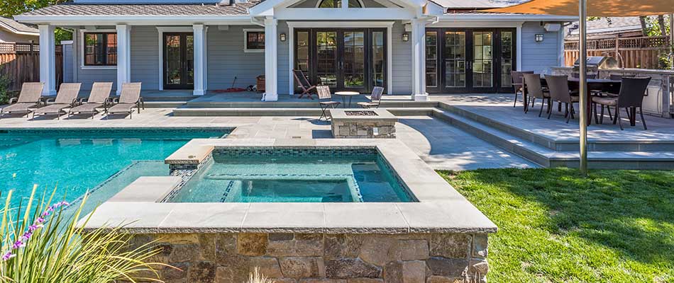 Outdoor living area with custom pool in Grimes, IA.