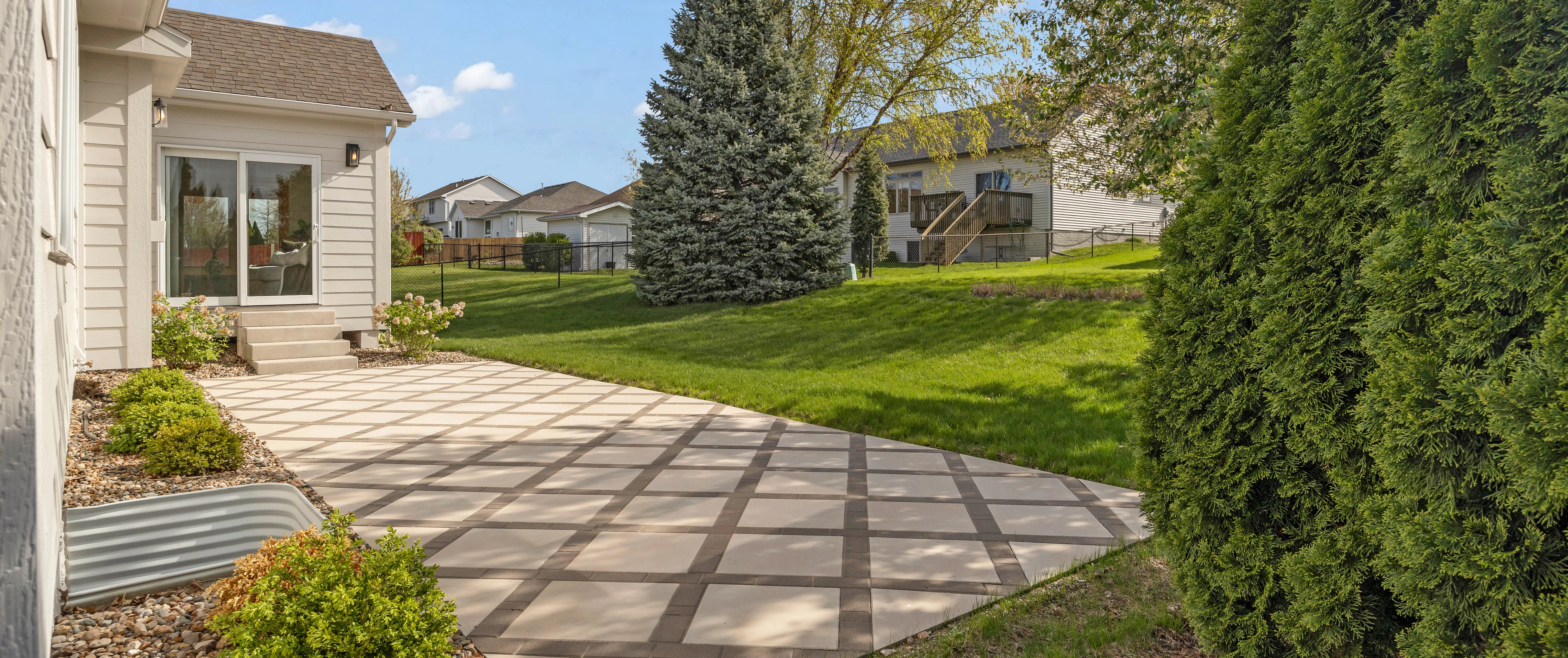 A stylish patio dining space featuring a round table with chairs and a comfortable lounging area, perfect for gatherings in Ankeny, IA.