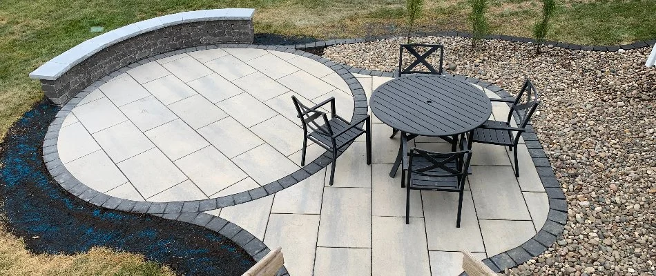 Patio with seating wall, table, and chairs on a property in Hiawatha, IA.