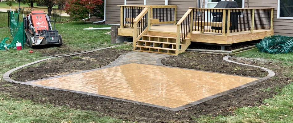 Patio installed beside deck in Bondurant, IA.