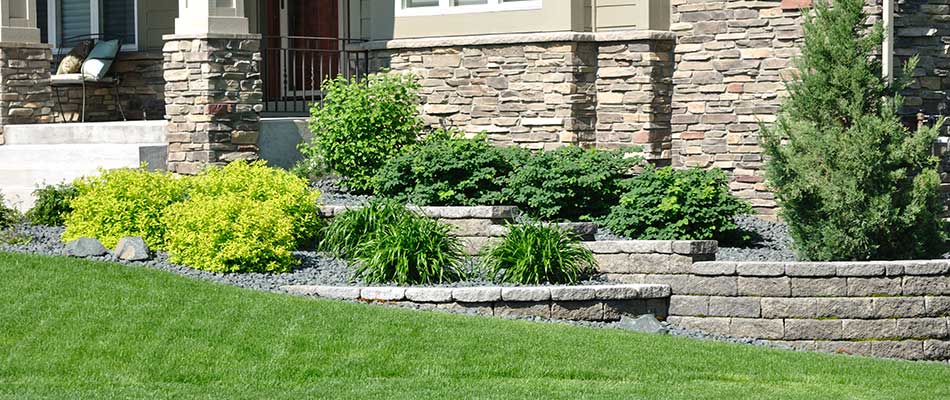 Retaining wall installed around mulch beds near Polk City, IA.