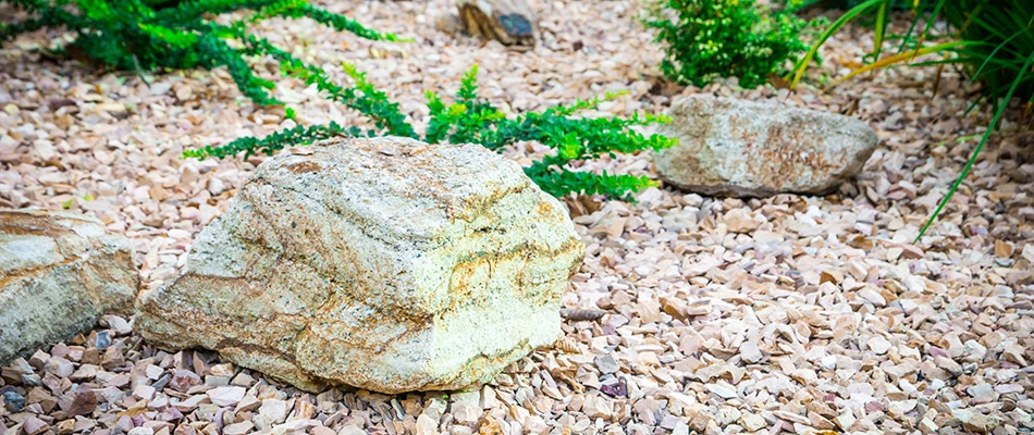 A rock covered landscape bed next to a home in Elkhart, IA. 