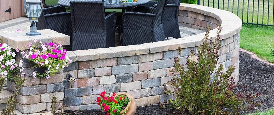 Seating wall built around an outdoor kitchen in Saylorville, IA.