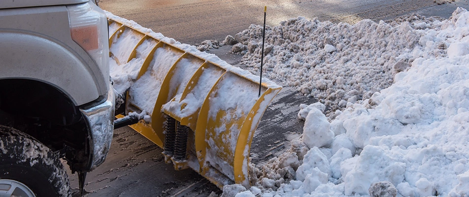 Truck plow removing snow from road in Urbandale, IA.